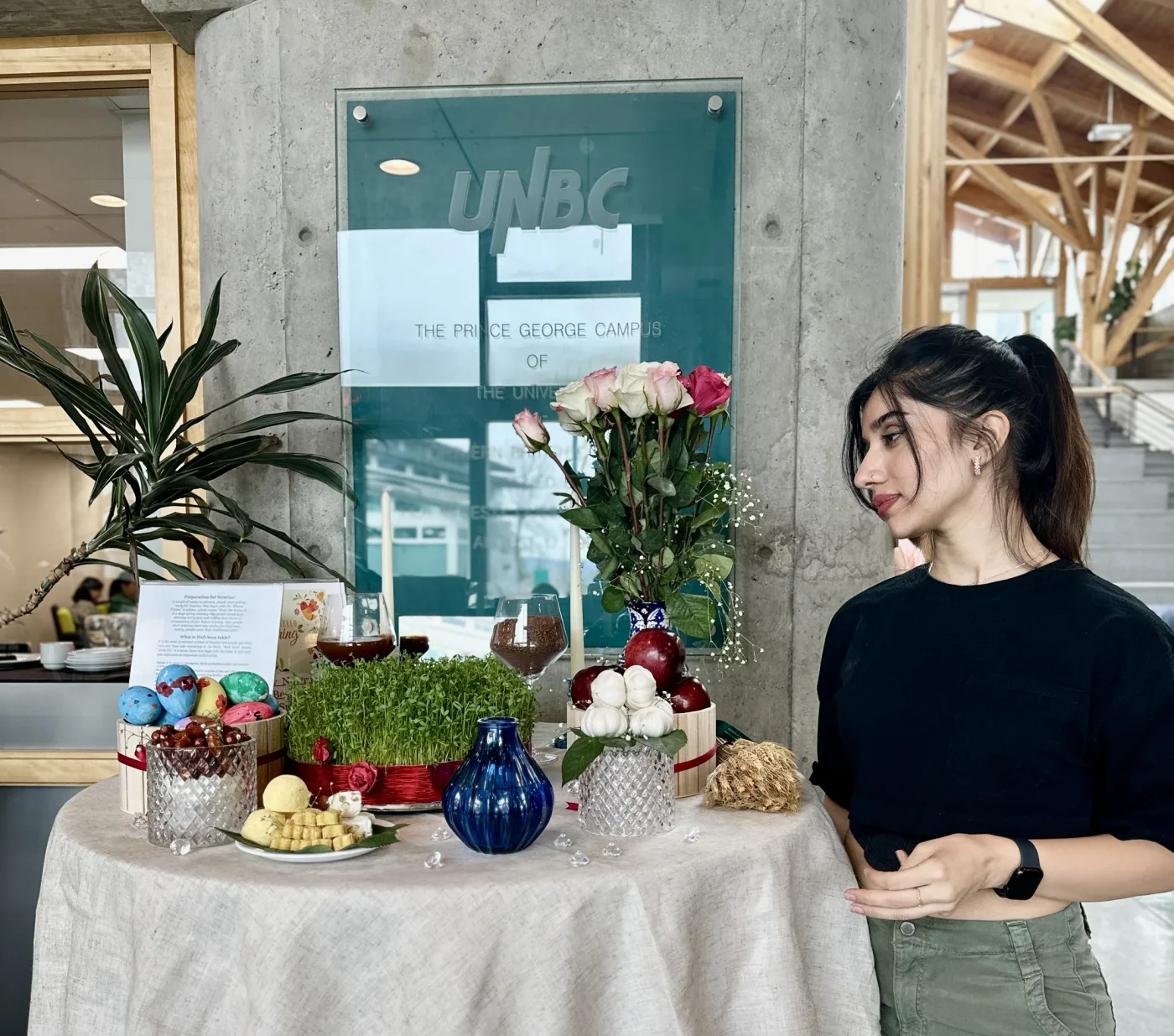 A personal photograph beside a table with flowers and decorative objects.