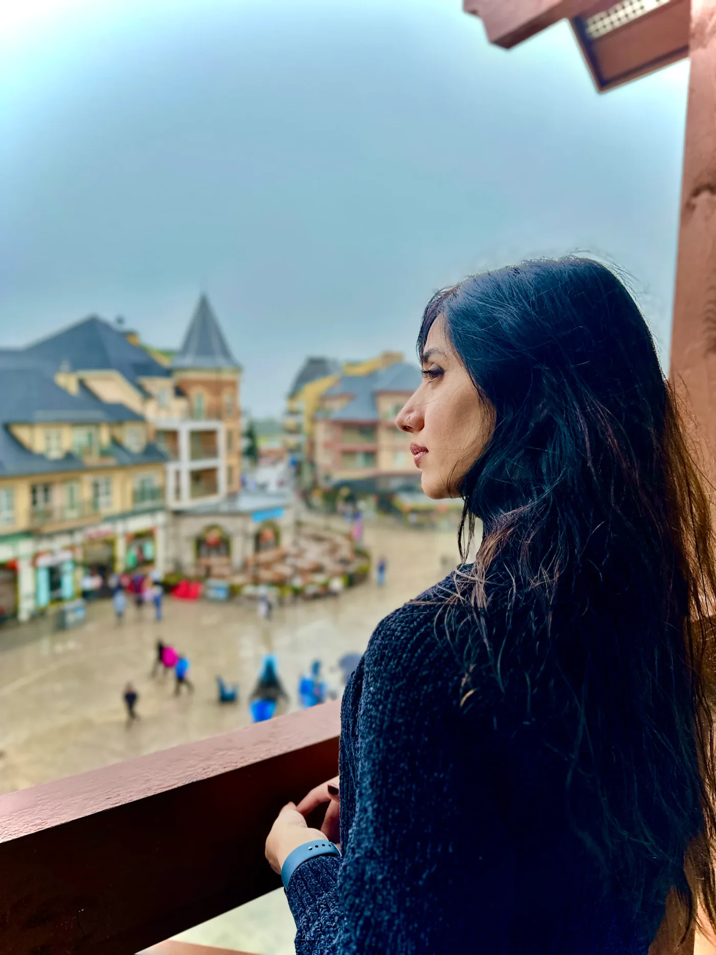 Looking out over buildings and a pedestrian street from a balcony.