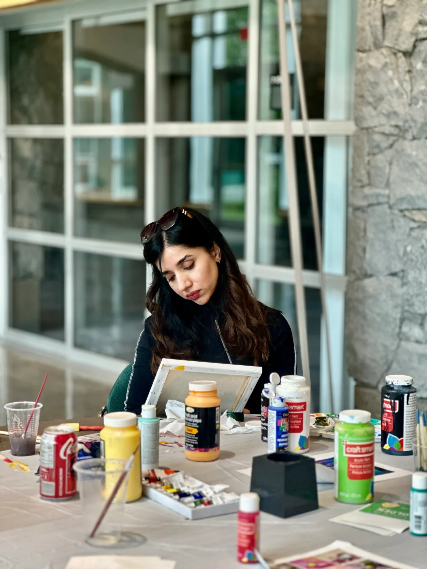 A personal photograph painting at a table with art materials.